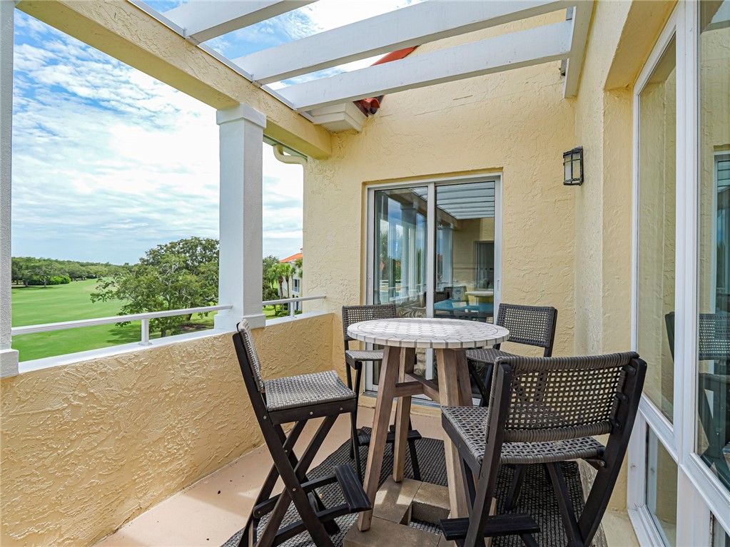 5060 Harmony Circle, Unit 304 Vero Beach, FL 32967 - Photo 32 of 36 a view of an outdoor dining space with a table and chairs