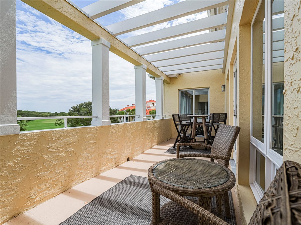 5060 Harmony Circle, Unit 304 Vero Beach, FL 32967 - Photo 34 of 36 a living room with furniture and a floor to ceiling window