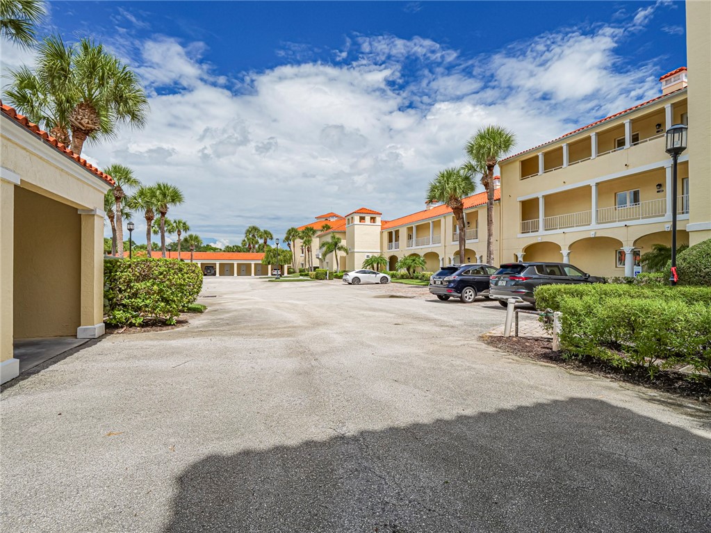 5060 Harmony Circle, Unit 304 Vero Beach, FL 32967 - Photo 5 of 36 a city street lined with buildings and trees