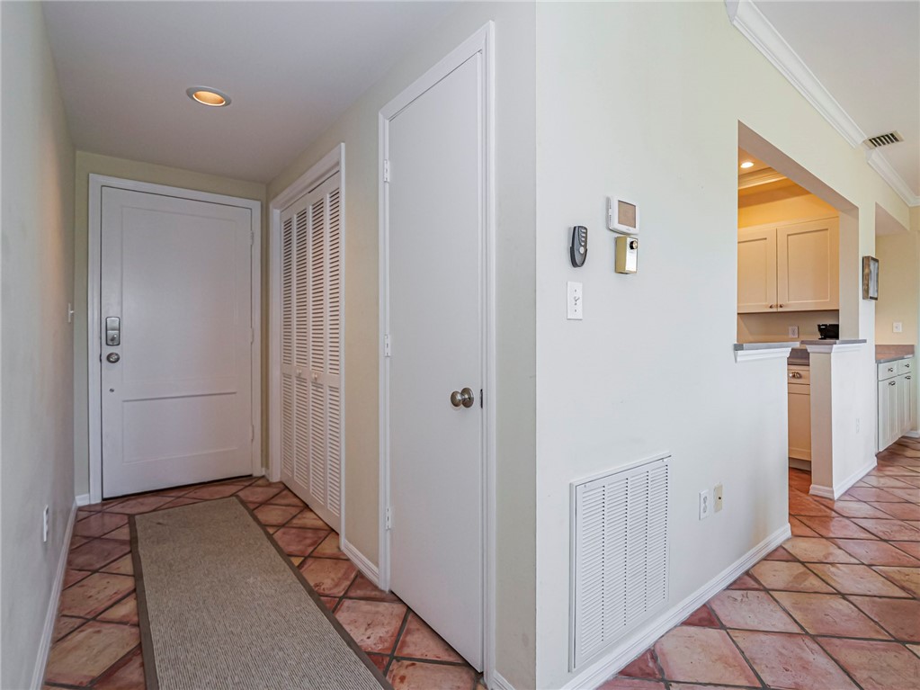 5060 Harmony Circle, Unit 304 Vero Beach, FL 32967 - Photo 8 of 36 a view of a hallway with wooden floor and entryway