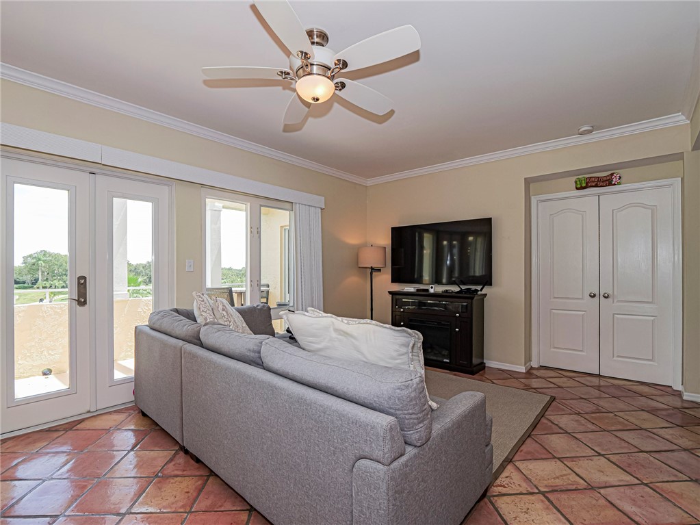 5060 Harmony Circle, Unit 304 Vero Beach, FL 32967 - Photo 9 of 36 a living room with furniture and a flat screen tv