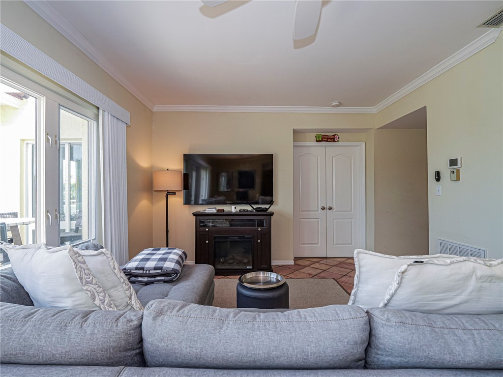 5060 Harmony Circle, Unit 304 Vero Beach, FL 32967 - Photo 10 of 36 a living room with furniture and a flat screen tv