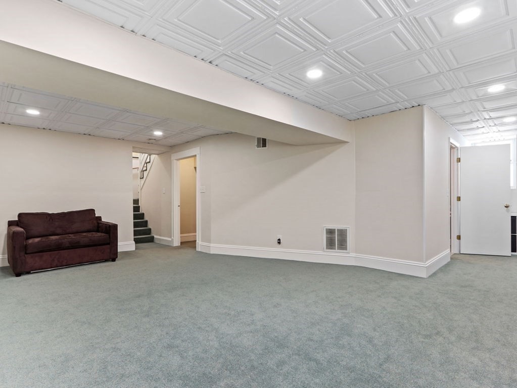 53 Marshall Street Newton, MA 02459 - Photo 35 of 42 an empty room with a ceiling fan and wooden floor