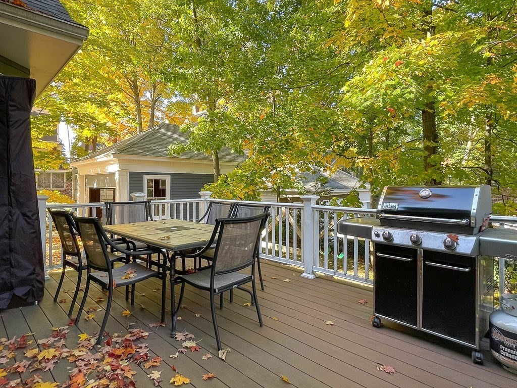 53 Marshall Street Newton, MA 02459 - Photo 41 of 42 a roof deck with a dining table and chairs with wooden floor