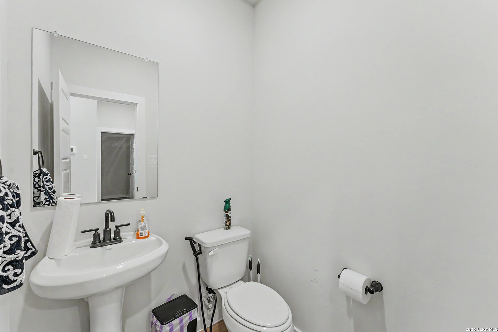 16515 Rosemary Ridge Elmendorf, TX 78112 - Photo 12 of 27 a bathroom with a sink mirror and toilet