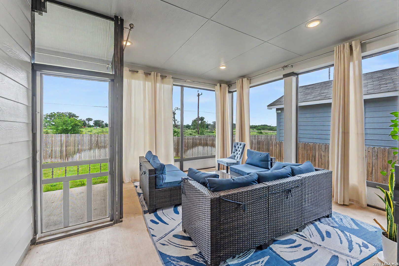 16515 Rosemary Ridge Elmendorf, TX 78112 - Photo 25 of 27 a living room with furniture and a floor to ceiling window