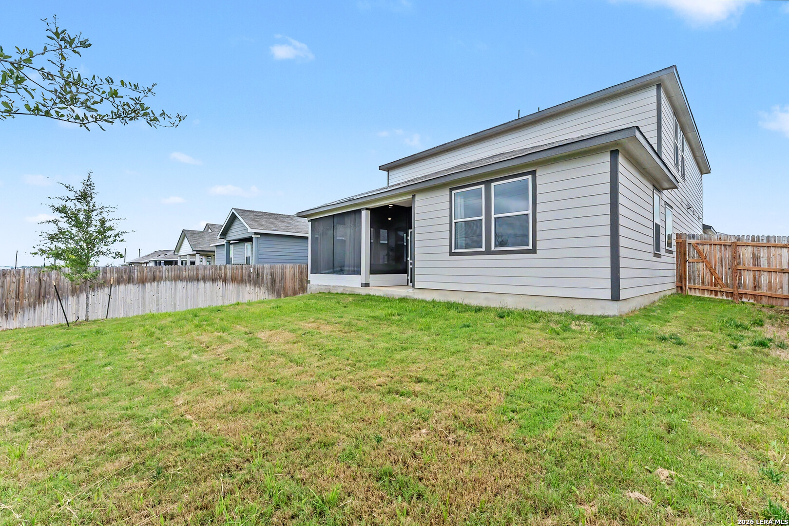 16515 Rosemary Ridge Elmendorf, TX 78112 - Photo 26 of 27 a view of a house with a backyard