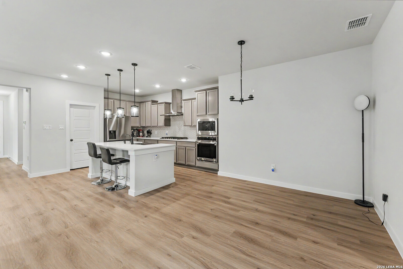 16515 Rosemary Ridge Elmendorf, TX 78112 - Photo 7 of 27 a kitchen with kitchen island a sink and a stove top oven