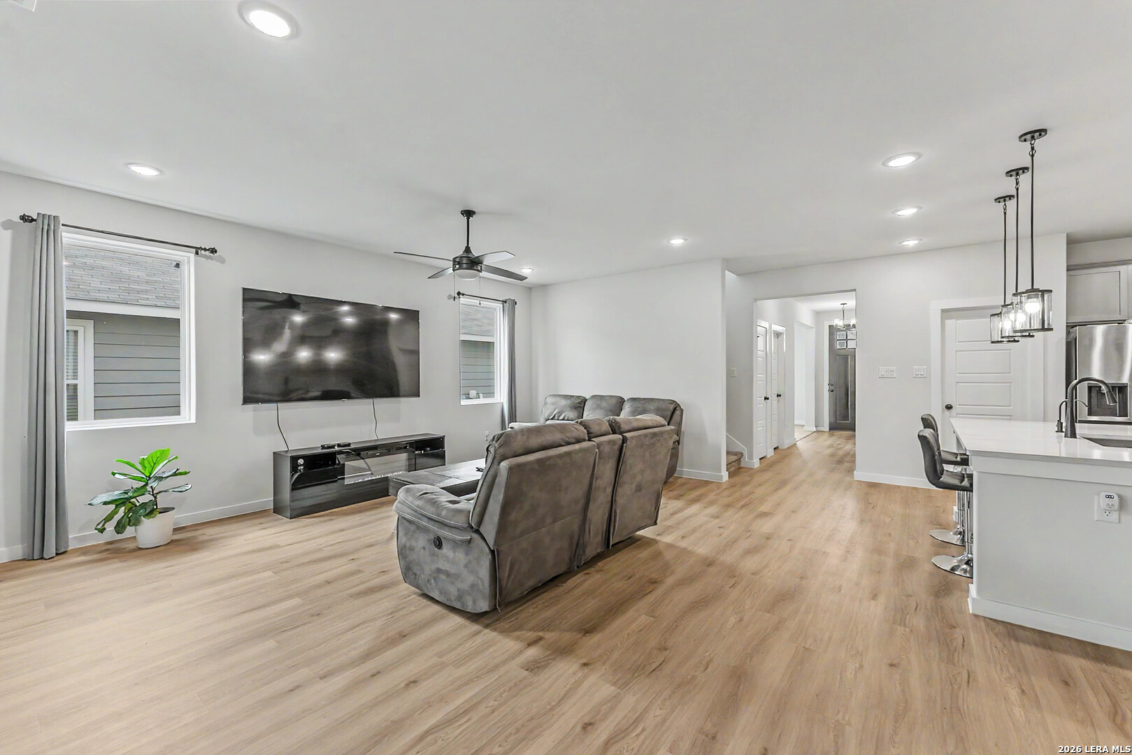 16515 Rosemary Ridge Elmendorf, TX 78112 - Photo 8 of 27 a living room with furniture and a flat screen tv