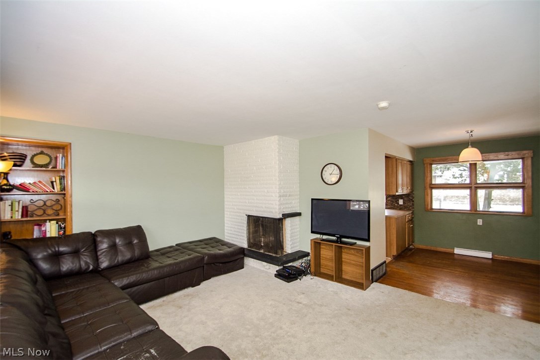 264 Buffington Road Akron, OH 44333 - Photo 6 of 25 Living room - great space with built in-bookcase and unique corner fireplace. Hardwood area adjacent to living room is dining area
