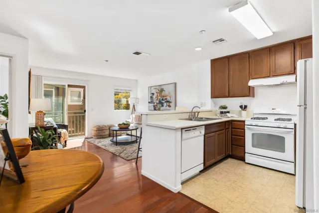 a kitchen with stainless steel appliances granite countertop a stove refrigerator and cabinets