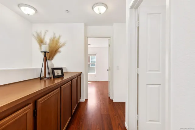 a view of a hallway with wooden floor