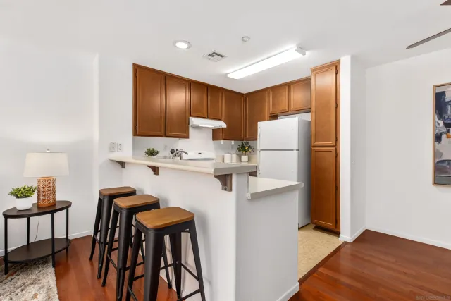a kitchen with stainless steel appliances a refrigerator and a stove top oven