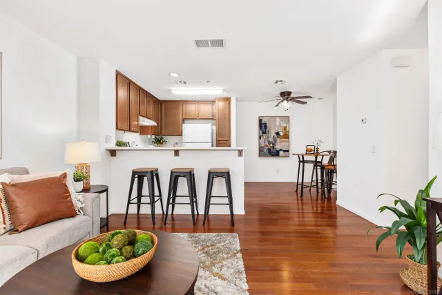 a living room with furniture a dining table and kitchen view