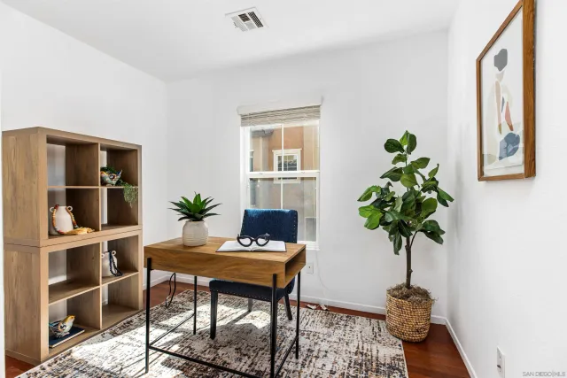 a room with furniture potted plant and wooden floor