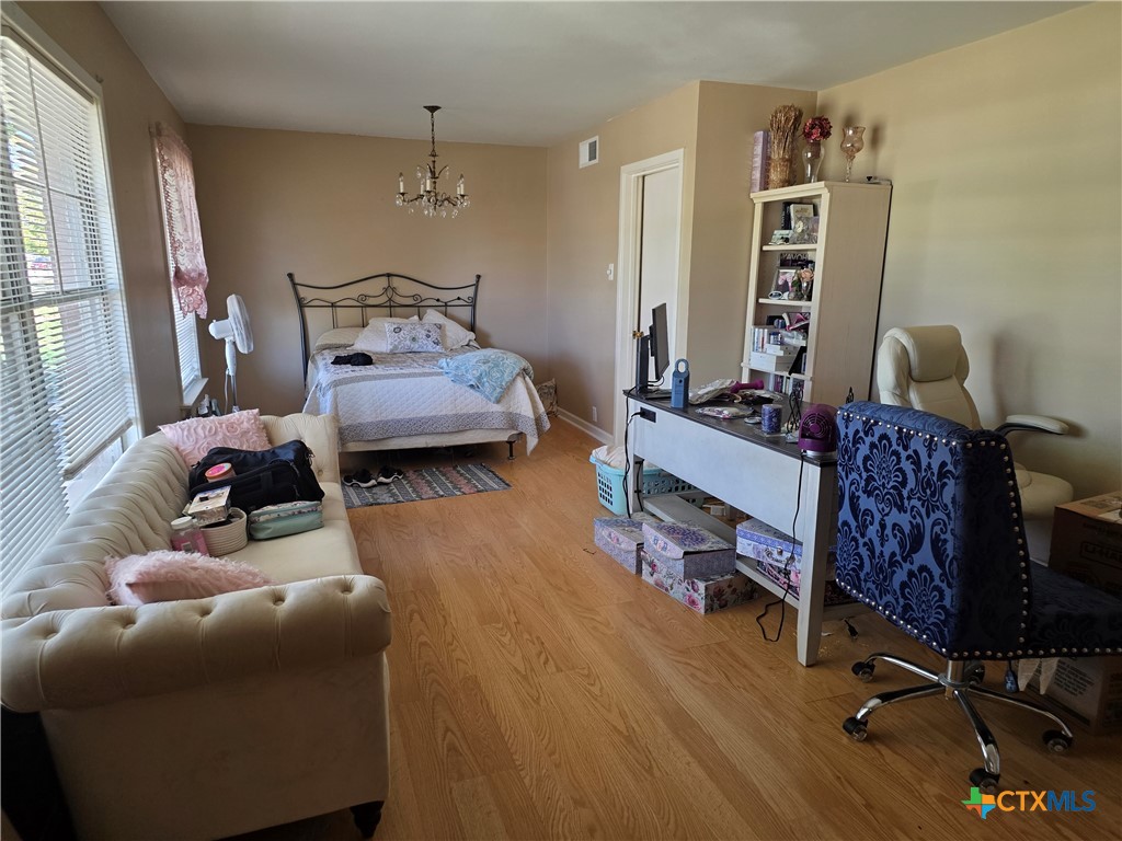 1903 South 13th Street Temple, TX 76504 - Photo 11 of 18 a bedroom with furniture and a wooden floor
