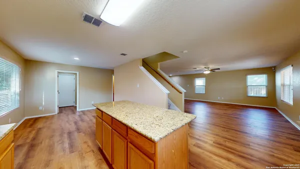 a view of an empty room and wooden floor