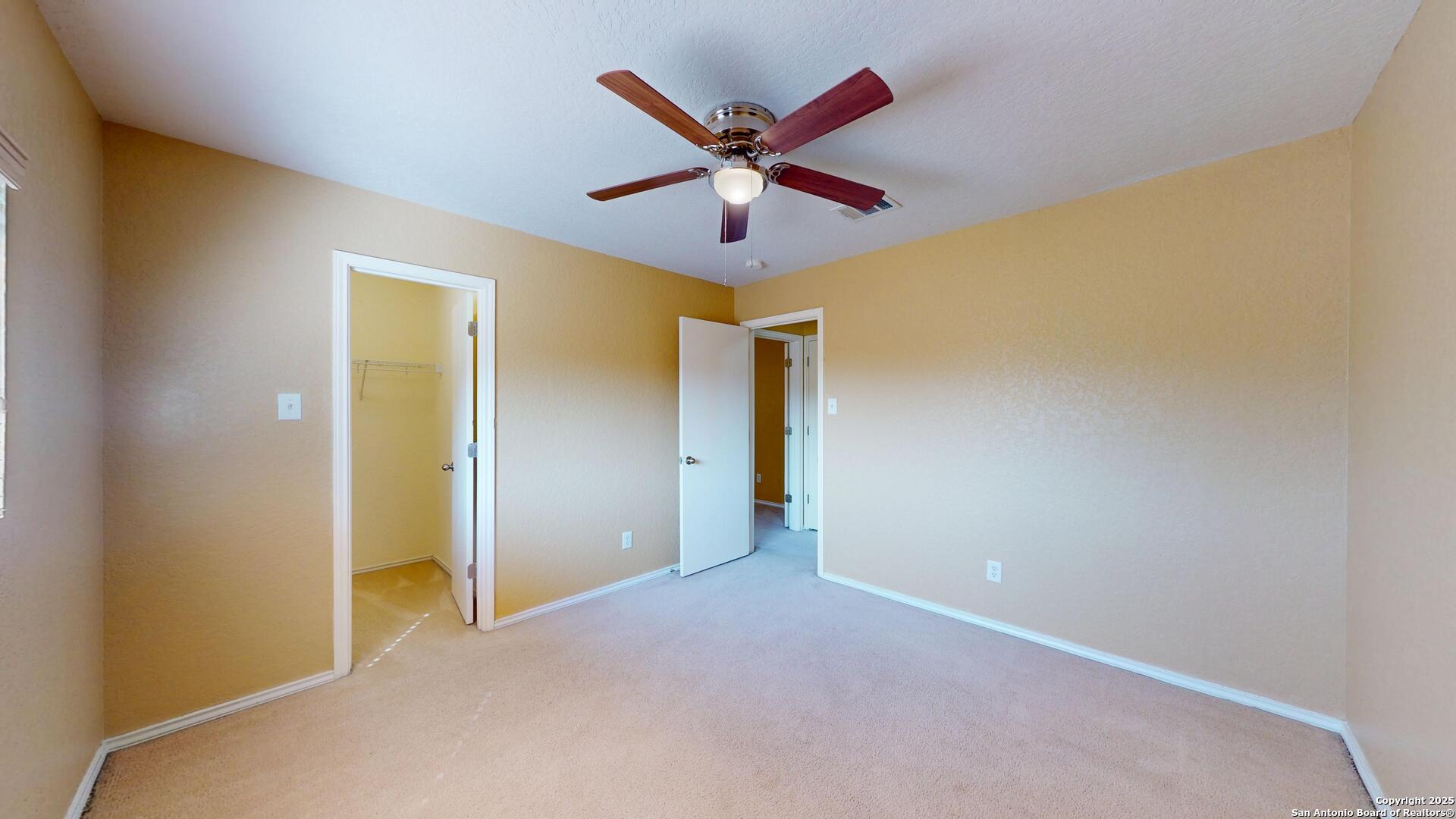 117 Foxglove Pass Cibolo, TX 78108 - Photo 26 of 46 a view of a hallway with a ceiling fan and wooden floor