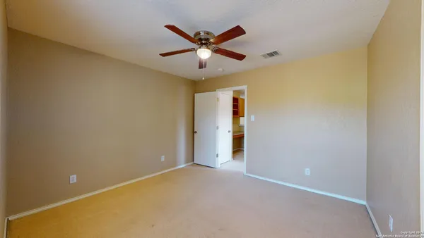 an empty room with ceiling fan and ceiling fan