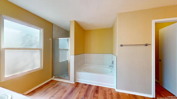 a bathroom with a bathtub and a shower