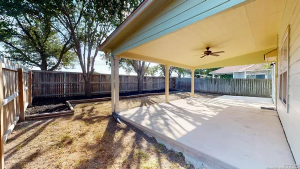 a view of a backyard with a wooden fence