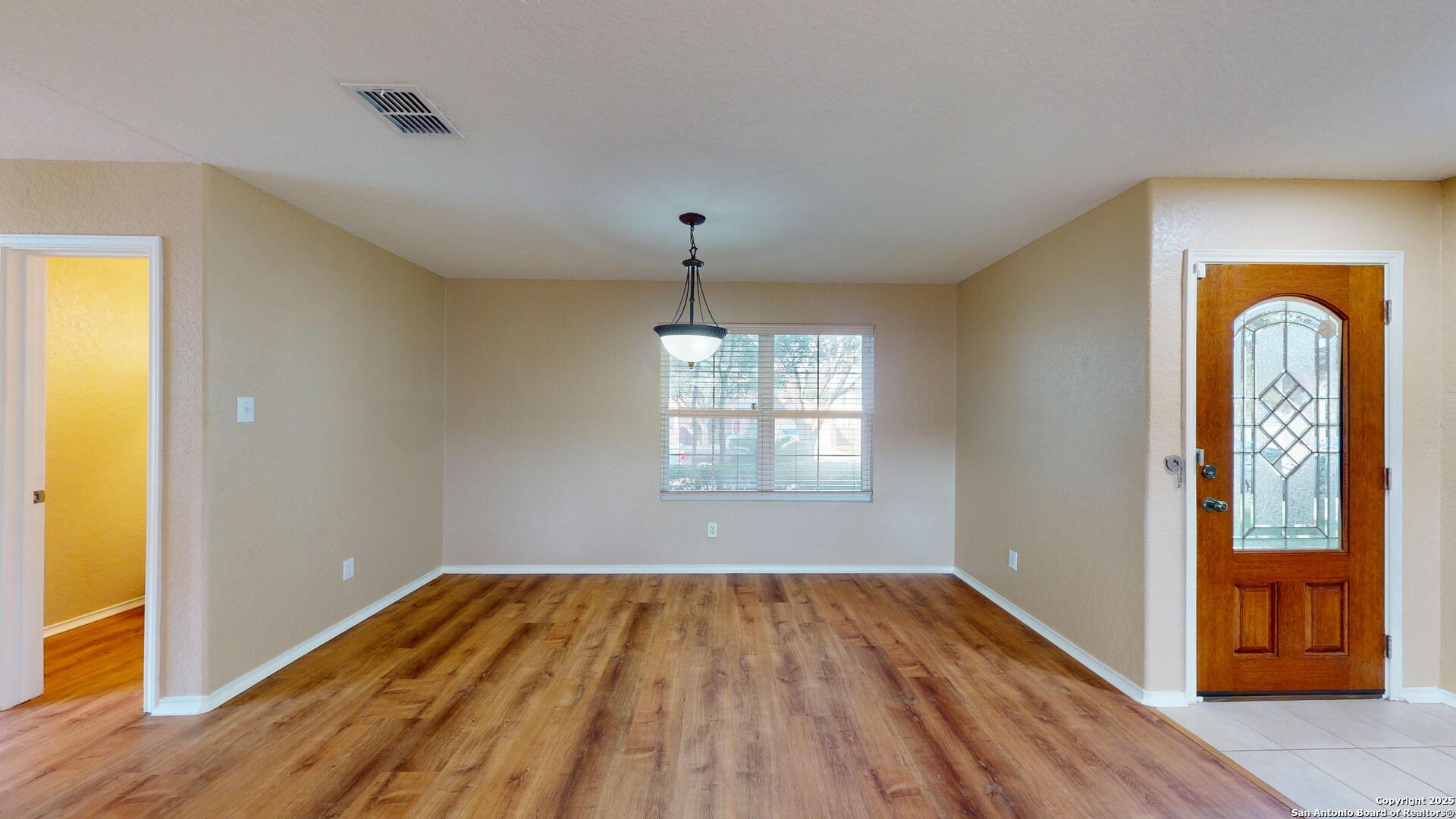 117 Foxglove Pass Cibolo, TX 78108 - Photo 7 of 46 a view of empty room with window and wooden floor