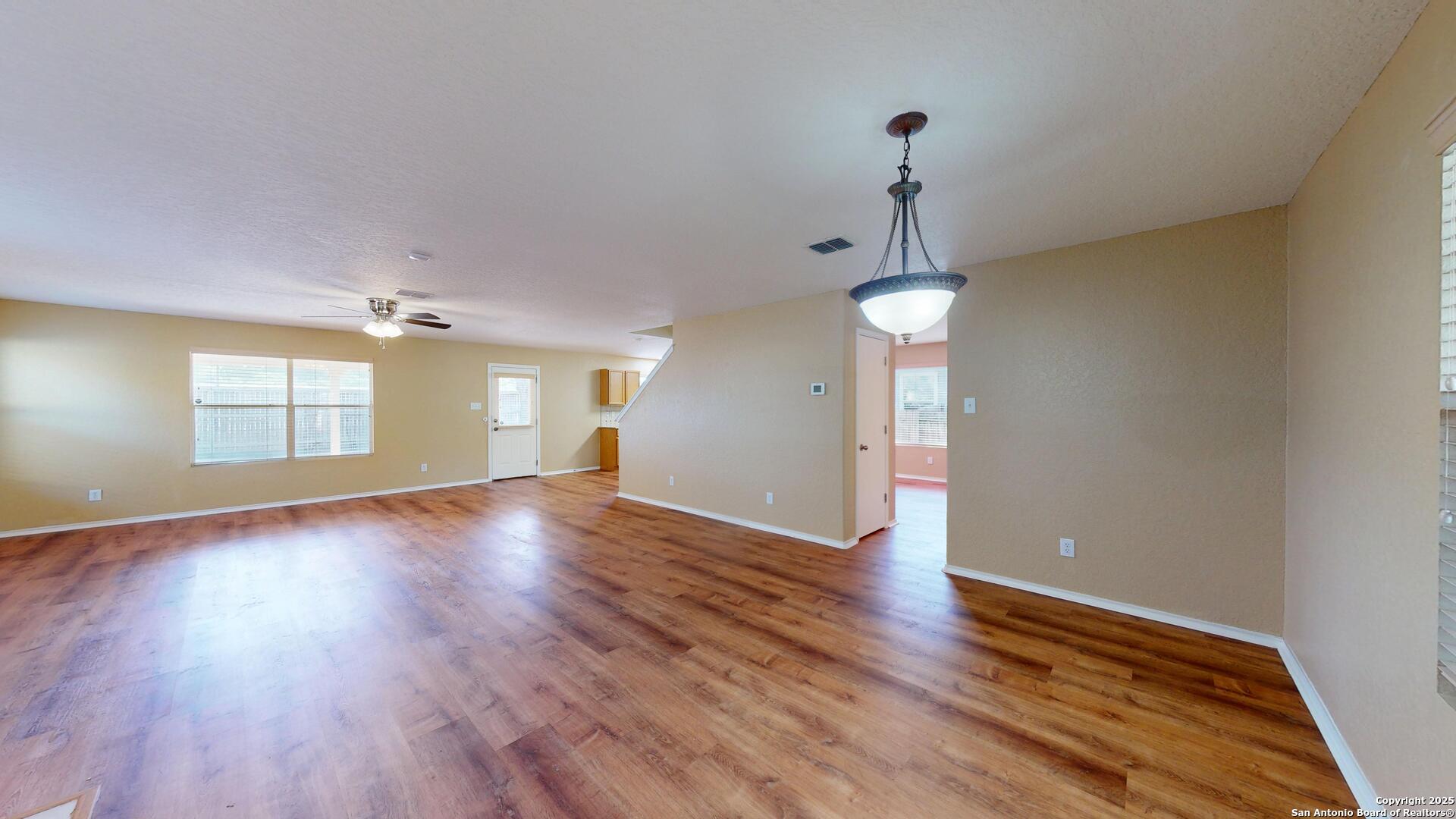 117 Foxglove Pass Cibolo, TX 78108 - Photo 8 of 46 a view of an empty room with wooden floor and fan