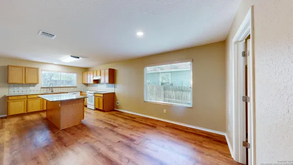 a view of a kitchen with a sink and a window