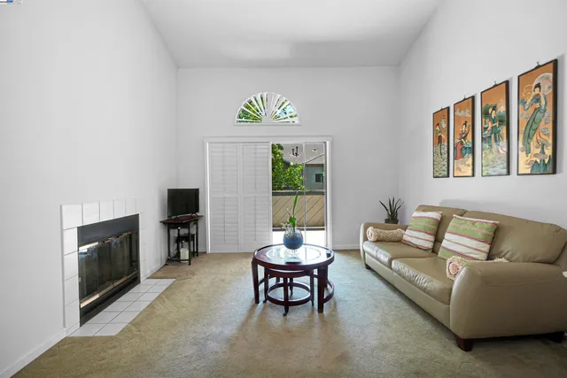 a living room with furniture fireplace and window