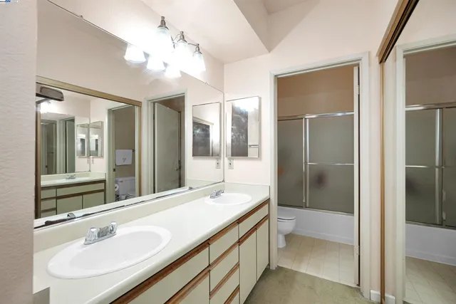 a bathroom with a sink double vanity and a shower