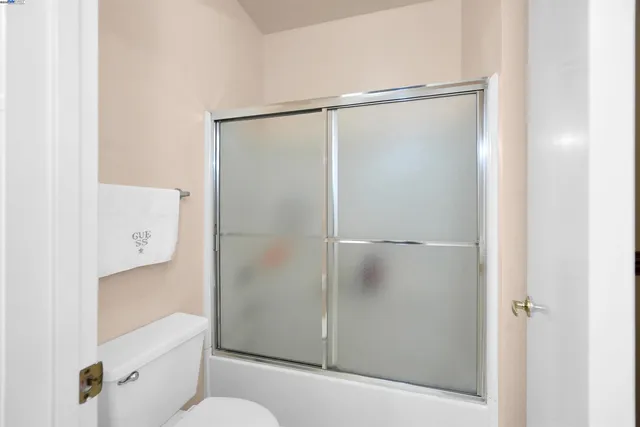 a bathroom with a shower and a toilet