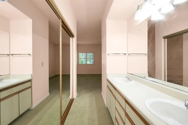 a bathroom with a tub sink and mirror