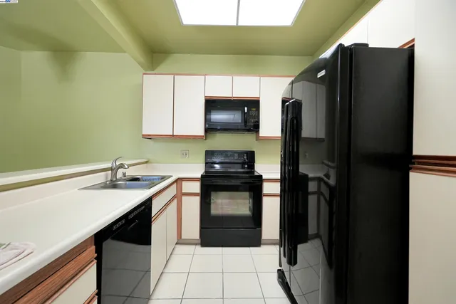 a kitchen with a sink and a refrigerator