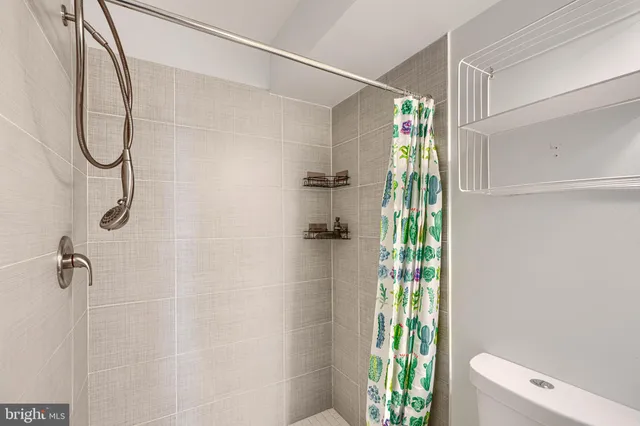 a bathroom with a shower and a shower curtain