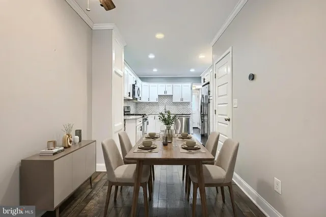a view of a dining room with furniture and wooden floor