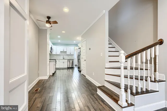 a view of entryway with wooden floor and staircase