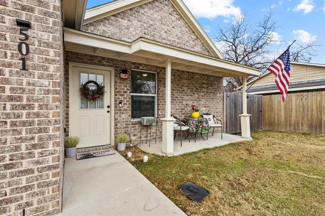 a view of a patio with table and chairs and potted plants
