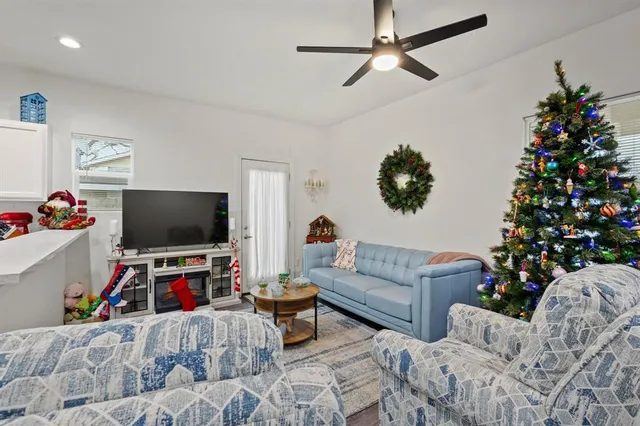 a living room with furniture and a flat screen tv