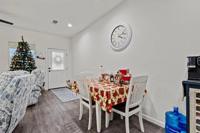 a dining room with furniture and wooden floor