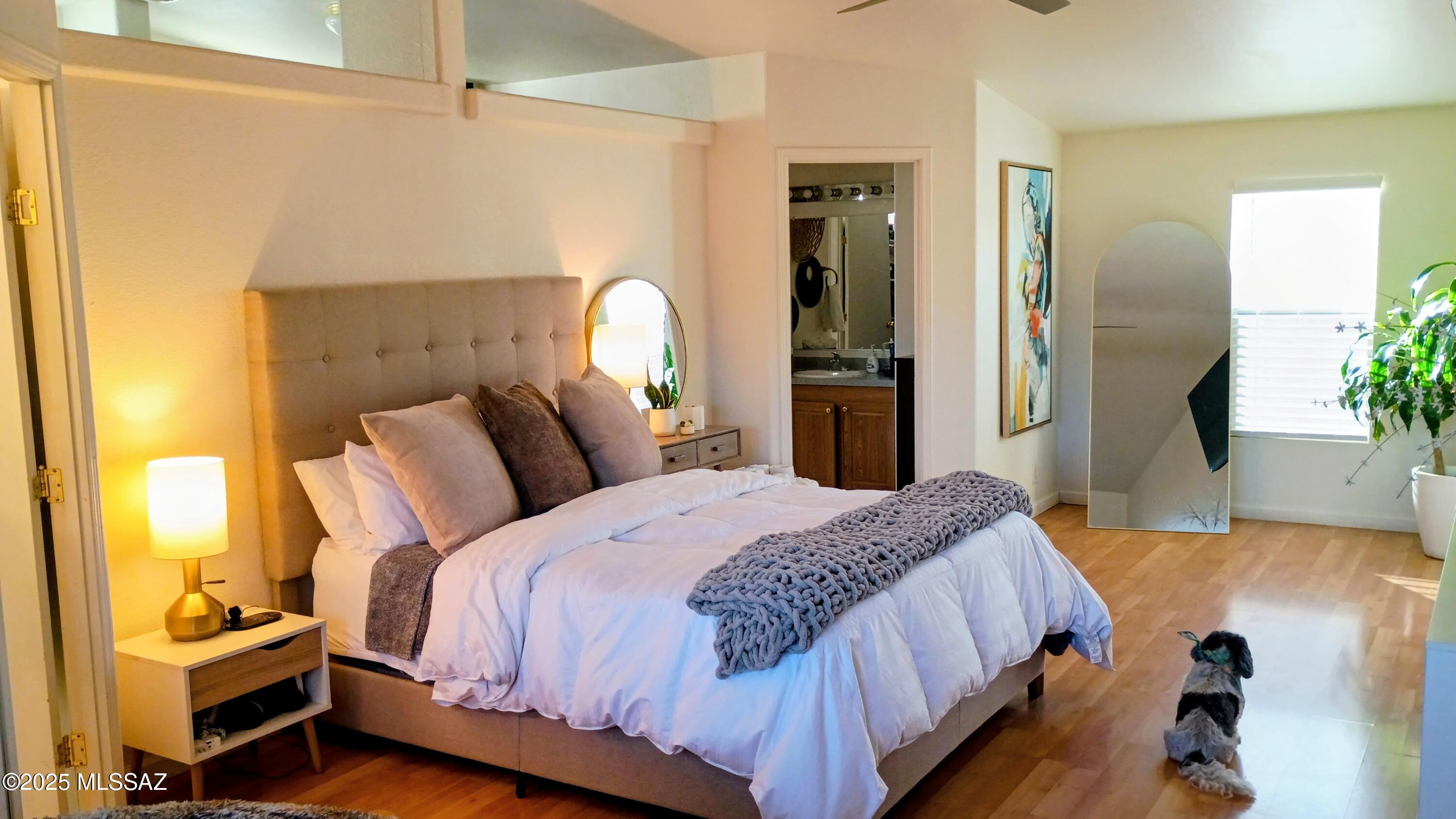 1449 West Hualpai Road Tucson, AZ 85745 - Photo 28 of 49 a bedroom with a bed and wooden floor