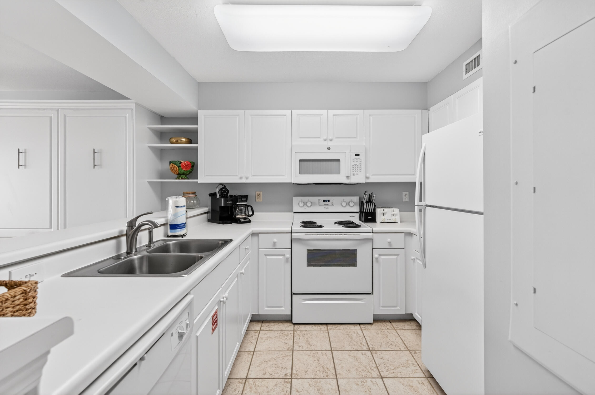 866 Santa Rosa Boulevard, Unit 317 Fort Walton Beach, FL 32548 - Photo 11 of 46 a kitchen with white cabinets and white appliances