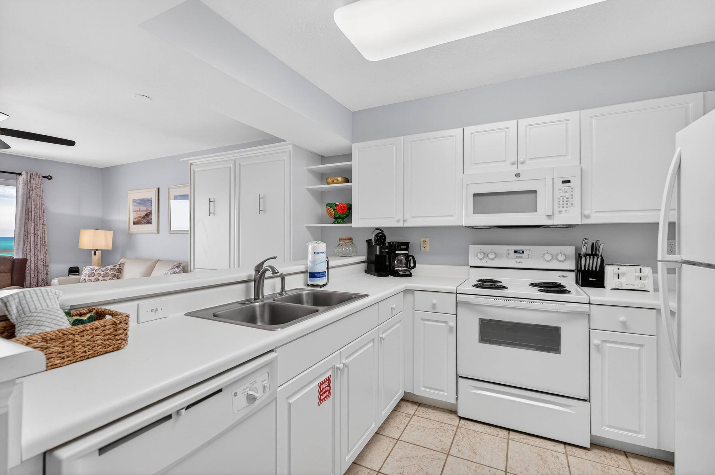 866 Santa Rosa Boulevard, Unit 317 Fort Walton Beach, FL 32548 - Photo 12 of 46 a kitchen with white cabinets sink and white appliances