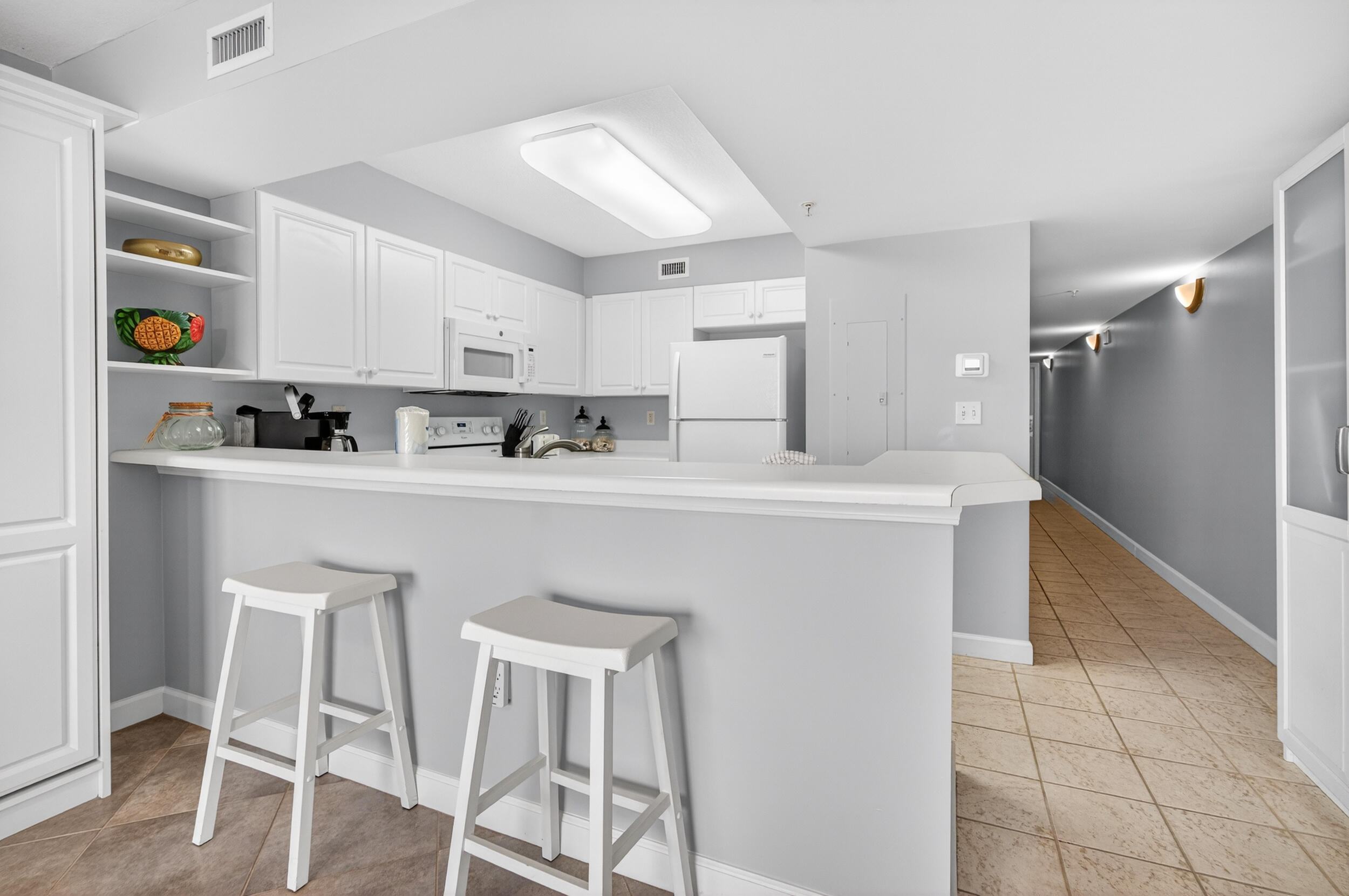 866 Santa Rosa Boulevard, Unit 317 Fort Walton Beach, FL 32548 - Photo 18 of 46 a kitchen with stainless steel appliances a sink a stove a refrigerator cabinets and dining table