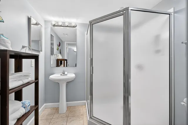 a bathroom with a shower and a sink