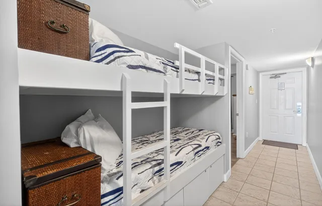 a view of bedroom with a bed and cabinets