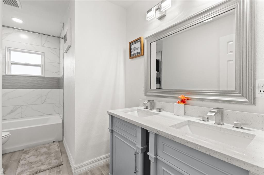 812 Chastain Road Seffner, FL 33584 - Photo 17 of 26 a bathroom with a sink and a mirror