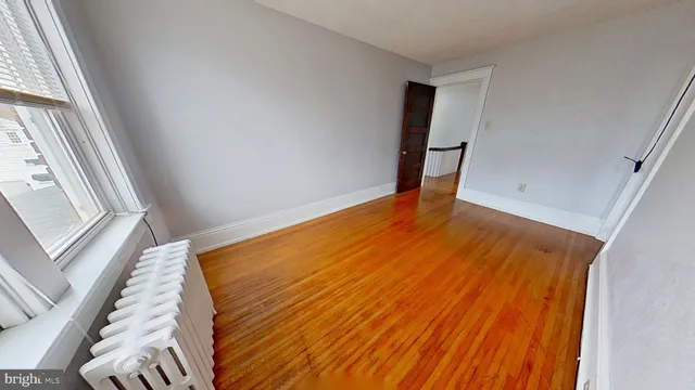 a view of a room with wooden floor and chair