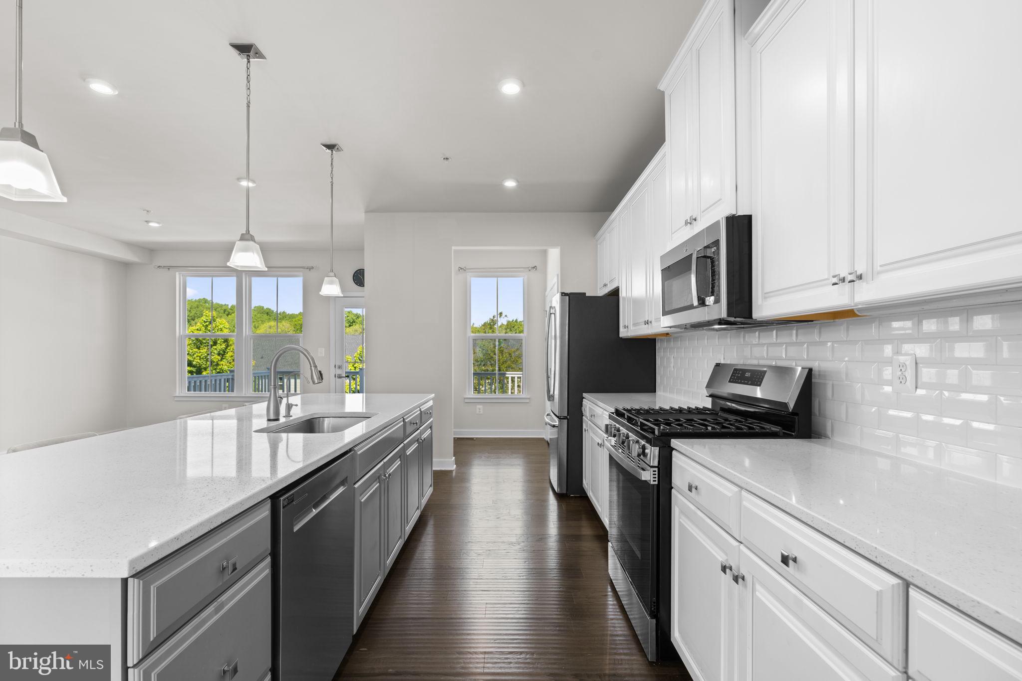 733 Iron Gate Road Bel Air, MD 21014 - Photo 11 of 41 a kitchen with stainless steel appliances granite countertop a sink a stove top oven a counter space and cabinets