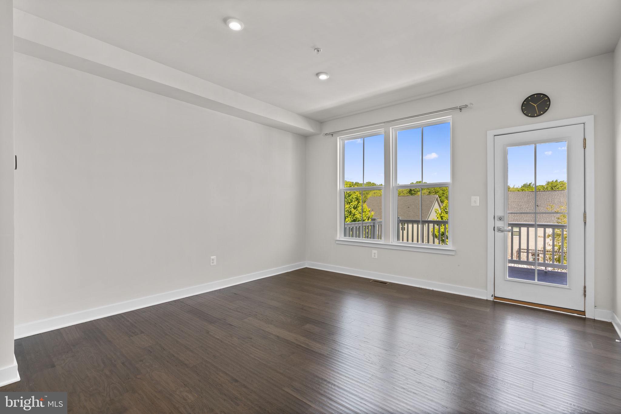 733 Iron Gate Road Bel Air, MD 21014 - Photo 15 of 41 an empty room with wooden floor and windows