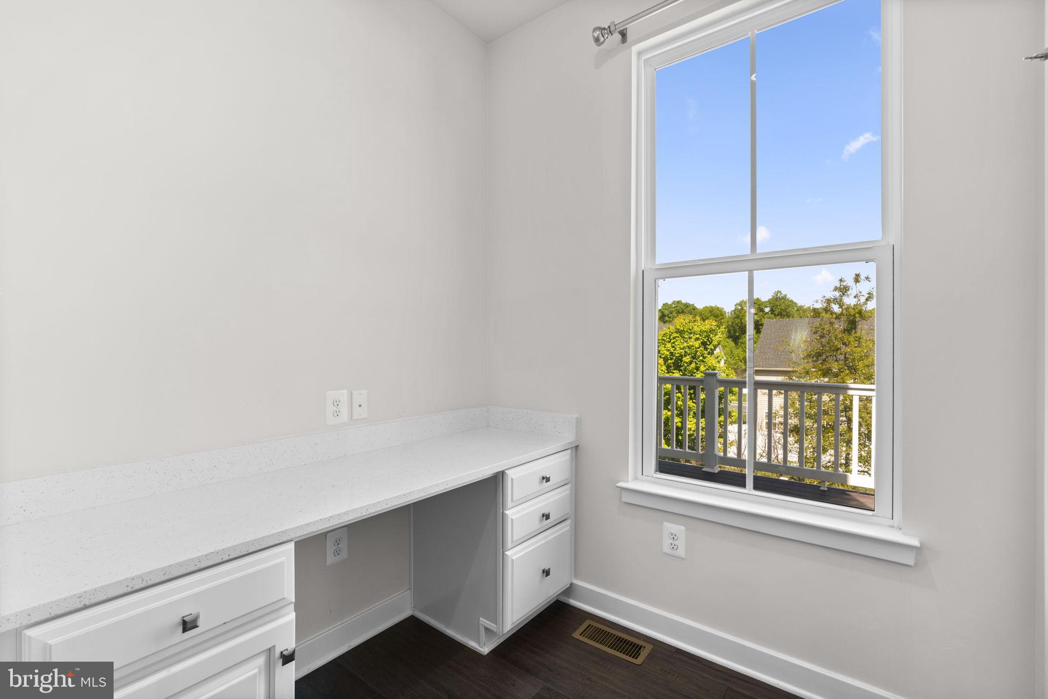 733 Iron Gate Road Bel Air, MD 21014 - Photo 16 of 41 a room with a white cabinets and a window